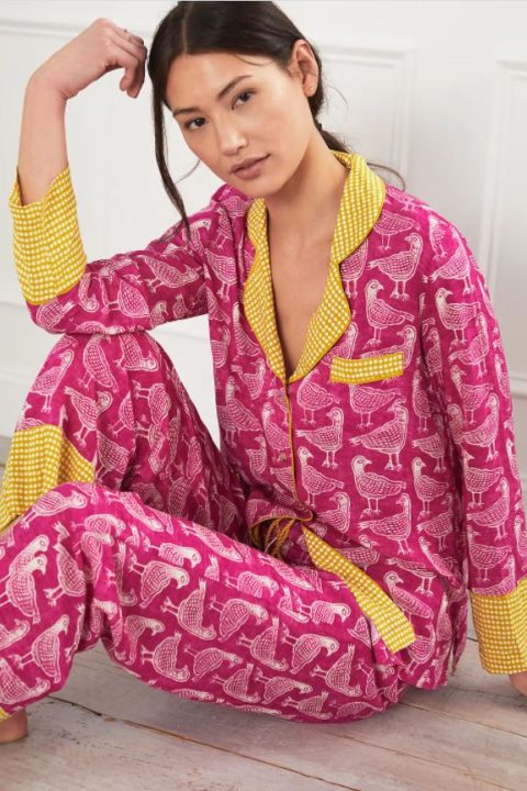 Photo of a model wearing pink and yellow pajamas bearing one of Jen Hewett's prints for Anthropologie